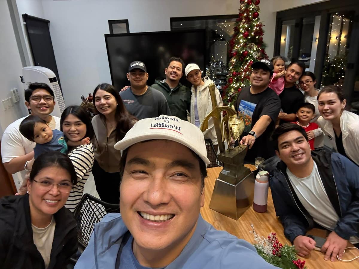 Bong Revilla taking a family group photograph after returning home.